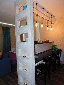 a ladder to a bar with a piano in a room at Lola Apartments in Banja Koviljača