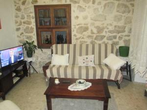 a living room with a couch and a tv at Vila Sipan in Šipanska Luka