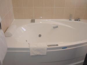a bath tub in a bathroom with a towel on it at Le Parasol in Ars-en-Ré