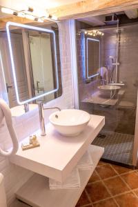 a bathroom with a white sink and a mirror at Hotel La Maison des Peyrat in Sarlat-la-Canéda