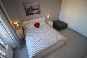 a bedroom with a bed with a red heart on it at Interno24 Apartment in La Spezia