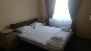 a bed room with a white bedspread and a white comforter at Кімнати в центрі in Uzhhorod