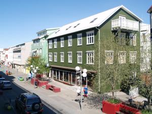 a green building on the side of a street at Akureyri Backpackers in Akureyri