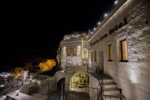a night view of a building with stairs and lights at Agarta Cave Hotel in Goreme +137 photos