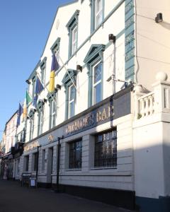 a large building with a clock on the front of it at Hayes Hotel in Thurles