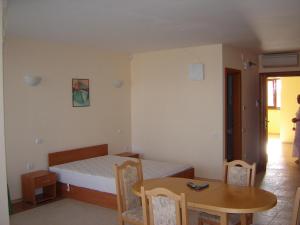 a bedroom with a bed and a table and a table and chairs at Byala Palace Apartments in Byala +152 photos