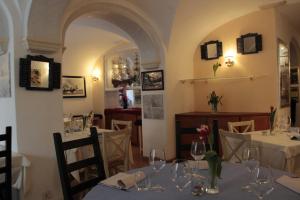 a restaurant with tables and chairs with wine glasses at Hotel Argentina in Santa Margherita Ligure