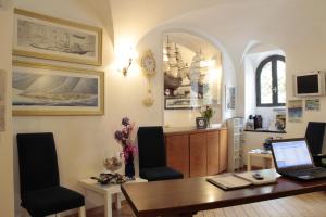 a dining room with a table with a laptop on it at Hotel Argentina in Santa Margherita Ligure