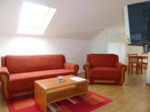 a living room with two chairs and a tv at House Sekulic in Grabovac