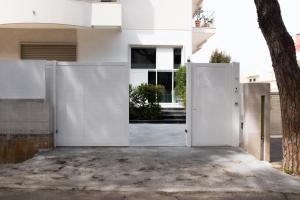 a white house with a white fence at Grey Loft in Polignano a Mare