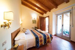 a bedroom with a bed in a room with a window at San Giacomo in SantʼAlessio Siculo