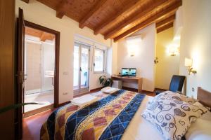a bedroom with a bed and a desk and window at San Giacomo in SantʼAlessio Siculo