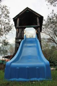 a blue plastic slide in a play house at Apartments Zara & Jan in Brzac