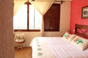 a bedroom with a large bed and a window at Hotel San Jorge in Tlatlauquitepec