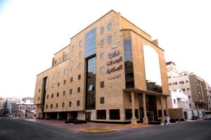 a building on the corner of a street at Rolana Furnished Apartments in Jeddah