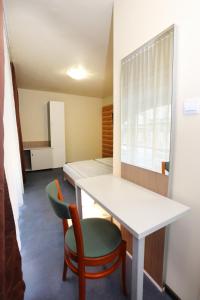 a room with a white table and a green chair at Mezzo Budapest in Budapest