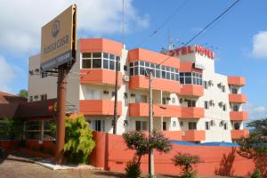 a building with a hotel sign in front of it at Hotel Nossa Casa in Ijuí