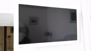 Televízia a/alebo spoločenská miestnosť v ubytovaní B&B La Porta Vecchia