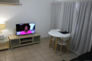 a living room with a tv and a chair at Best Western Ipswich in Ipswich