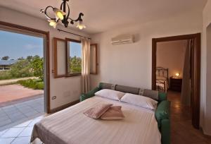 Postel nebo postele na pokoji v ubytování Agriturismo Sa Suerera