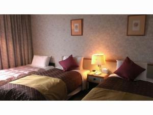 Katil atau katil-katil dalam bilik di Sky Hotel Uozu
