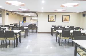 an empty dining room with tables and chairs at Leope Hotel in Cebu City