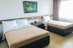 Postel nebo postele na pokoji v ubytování Leope Hotel