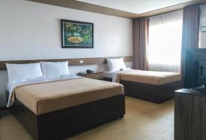 Postel nebo postele na pokoji v ubytování Leope Hotel