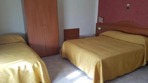 Postel nebo postele na pokoji v ubytování Hotel Dei Cappuccini