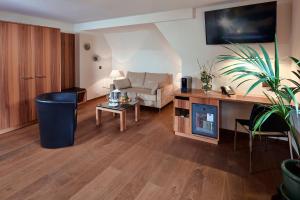 a living room with a couch and a table at Hotel Ambassador in Brig