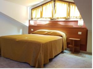 Postel nebo postele na pokoji v ubytování Hotel Dei Cappuccini