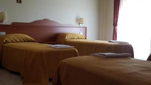 Postel nebo postele na pokoji v ubytování Hotel Dei Cappuccini