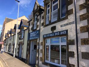 a row of buildings on a city street at Eastgate Apartment in Inverness