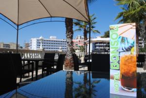 a drink sitting on a table on a balcony at Hotel Bonsol ADULTS ONLY in Lloret de Mar