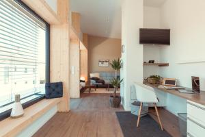 a kitchen and living room with a large window at Simply Home Apartments in Ueberackern