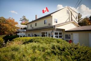 a building with a canadian flag on top of it at Robbins Motel in Bar Harbor