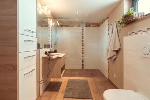 a small bathroom with a sink and a shower at Simply Home Apartments in Ueberackern +7 photos