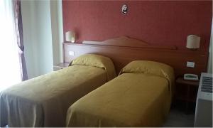 Postel nebo postele na pokoji v ubytování Hotel Dei Cappuccini