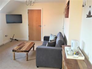 a living room with a couch and a coffee table at The Old Brewhouse in Arbroath