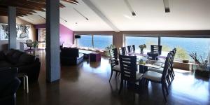 a living room with a table and chairs and the ocean at Unique Apartment Opatija in Opatija