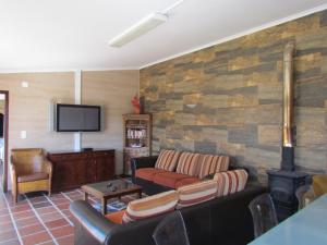 a living room with a couch and a flat screen tv at Quinta Do Forno in Vimeiro