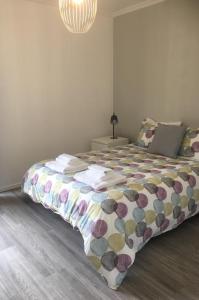 a bedroom with a bed with a colorful comforter at Feel Funchal in Funchal