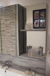 a bathroom sink with a mirror above a sink at Appartement centre Vichy in Vichy
