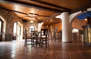 a dining room with tables and chairs in a building at Averto in Lefkada