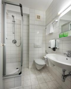 a bathroom with a toilet and a sink and a shower at Das Wismeyer in Obertauern