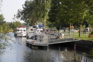 two boats are docked at a dock in the water at Chambres dhôtes Logette in Consenvoye +13 photos