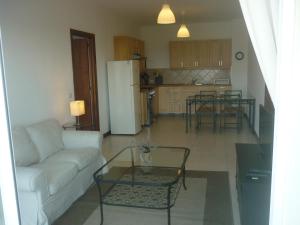 a living room and kitchen with a couch and a table at Maggy's House in La Romana