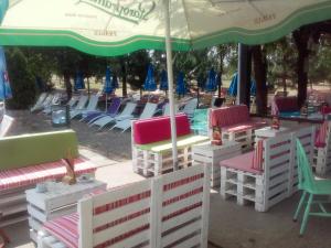 a group of chairs and umbrellas next to a pool at Apartment A&D in Pančevo