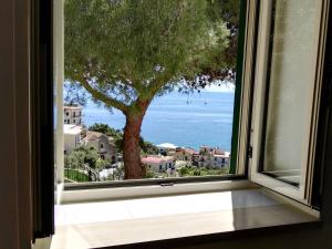 a window with a view of the ocean at Casa Vacanze Bouganvillea in Cetara
