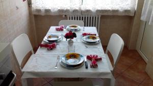 a white table with plates of food on it at Appartamento Corallo in Arona